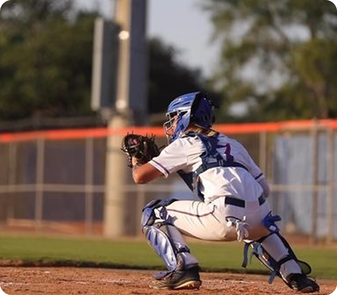 Catcher crouched behind home plate