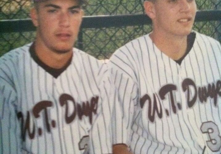 Young baseball team members posing