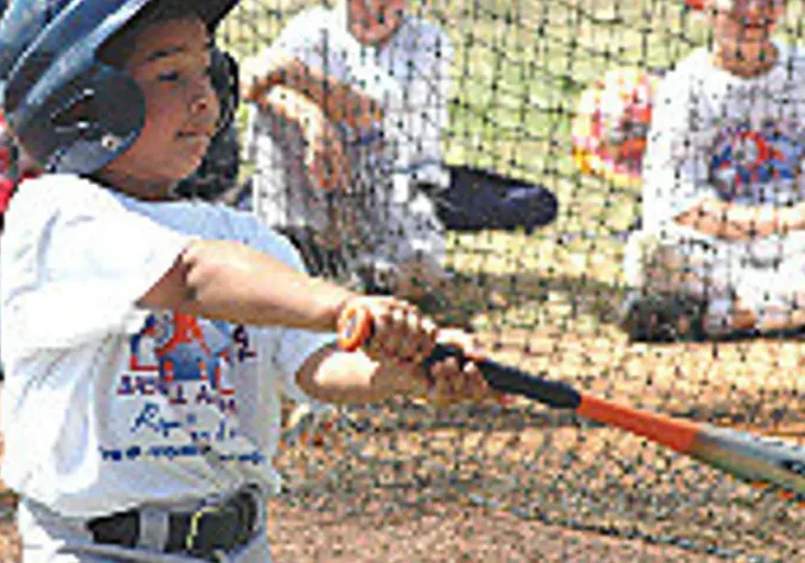 Kid hitting baseball at practice