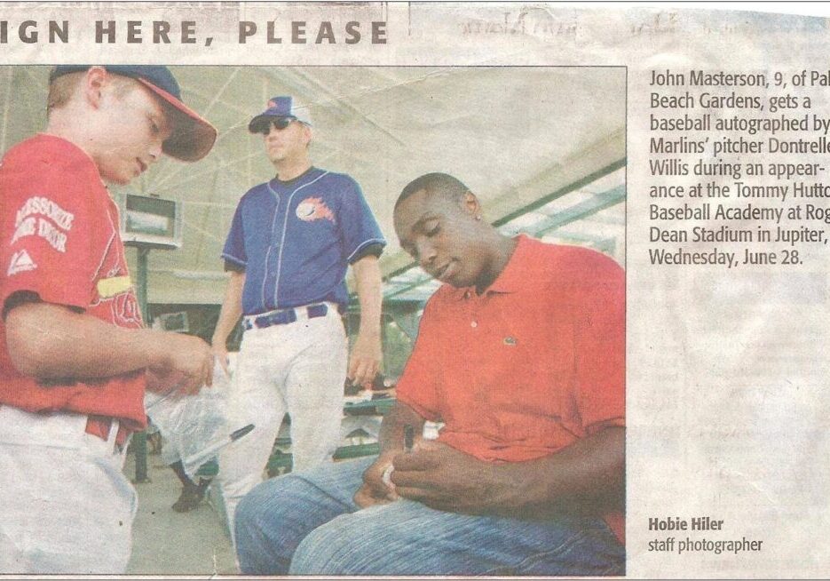 Player autographs baseball for child