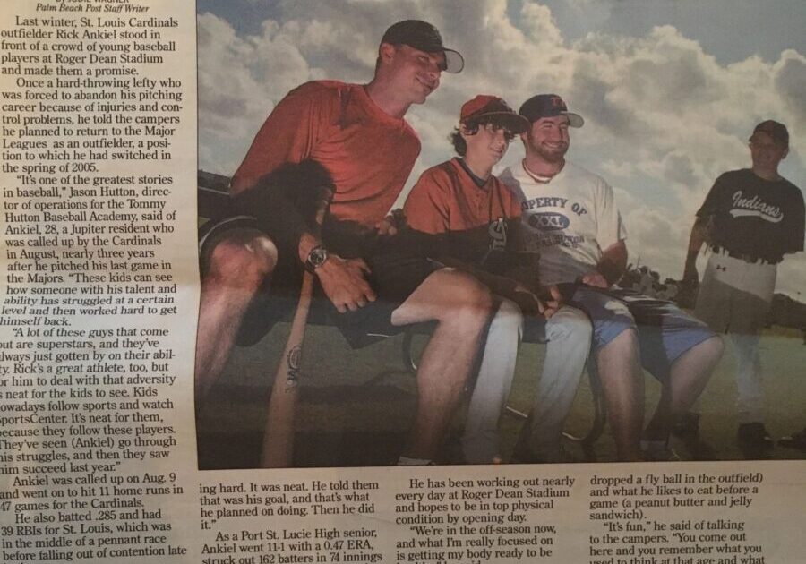 Group of baseball athletes sitting outside