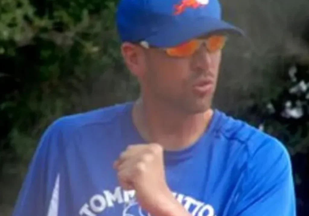 Man in blue sports cap and shirt