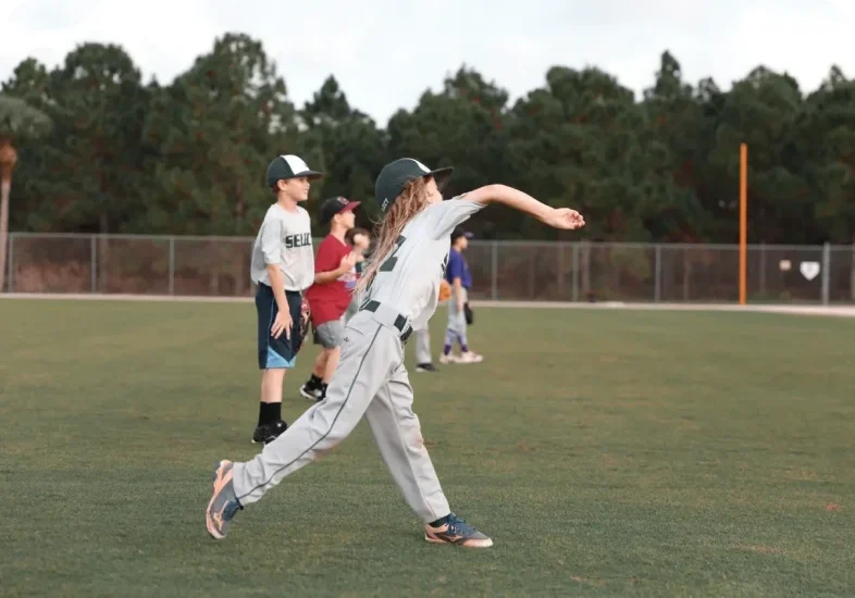 Young players throwing baseballs outdoors